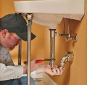 Southlake plumber inspects the sink pipe