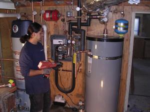 Trophy Club TX plumbing contractor checks a water heater