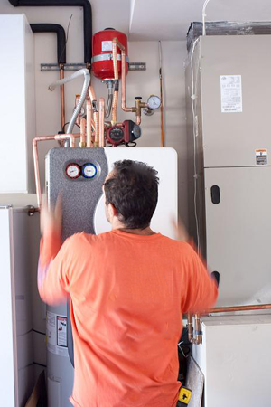 plumber in Trophy Club, Texas installing a tankless water heating system